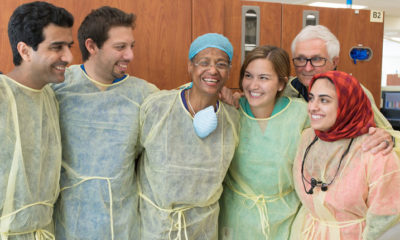 Fourth-year dental students Mohsen Khobyari, Roberto Olivares, Gabriela Aranda and Mariam Sayed join Associate Professor Kevin Gureckis, D.M.D. (back row right), in appreciating Cynthia Giles (center) and her longtime dedication to the School of Dentistry.