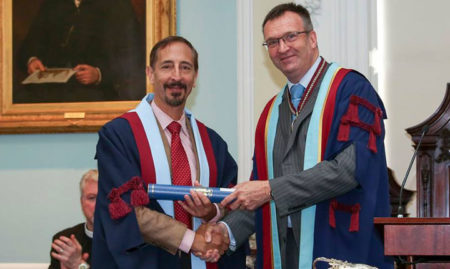 Professor Bill Saunders (right) of the Royal College of Surgeons of Edinburgh presents the award to Edward Ellis III, D.D.S., M.S., in Edinburgh.