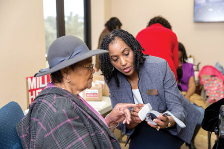 Venetia Cantrell, D.N.P., M.S.N., FNP-BC, monitors the blood pressure of a member of the Covenant Community Church in San Antonio.