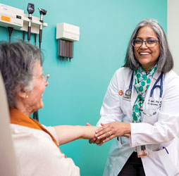 Neela K. Patel, M.D., M.P.H., CMD with a patient