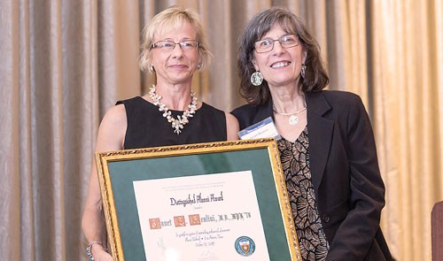 Ruth Berggren (left), M.D., director of the Center for Medical Humanities and Ethics, presents the 2017 alumna award to Janet P. Realini, M.D., M.P.H.