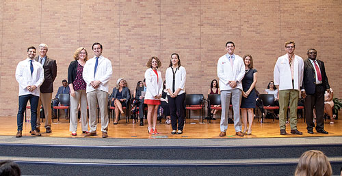 Dental students came on stage to don their white coats