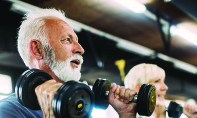 Man and woman lifting weights