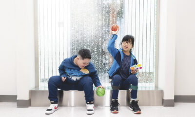 Two special need children play in front of the bubble wall in the lobby of the Hunke clinic.