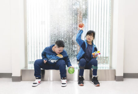 Two special need children play in front of the bubble wall in the lobby of the Hunke clinic.